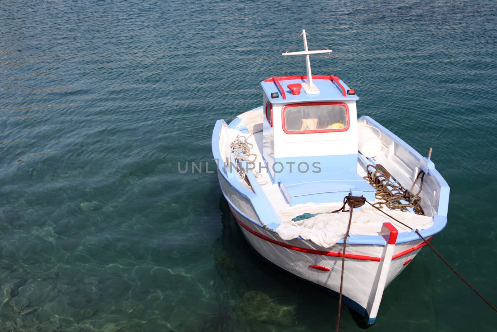 colorful traditional greek small wooden fishing boat moored