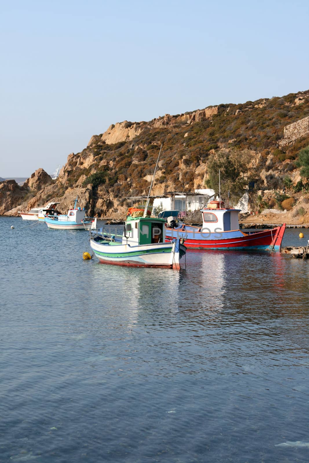 traditional greek fishing boats at harbor