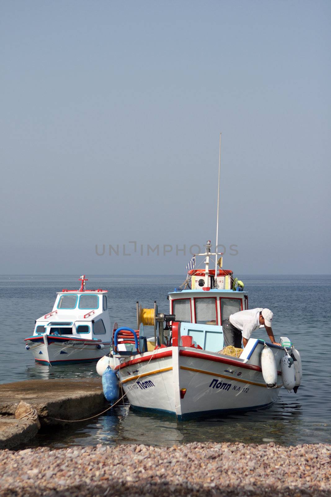 fisherman on boat   moored at patmos island greece