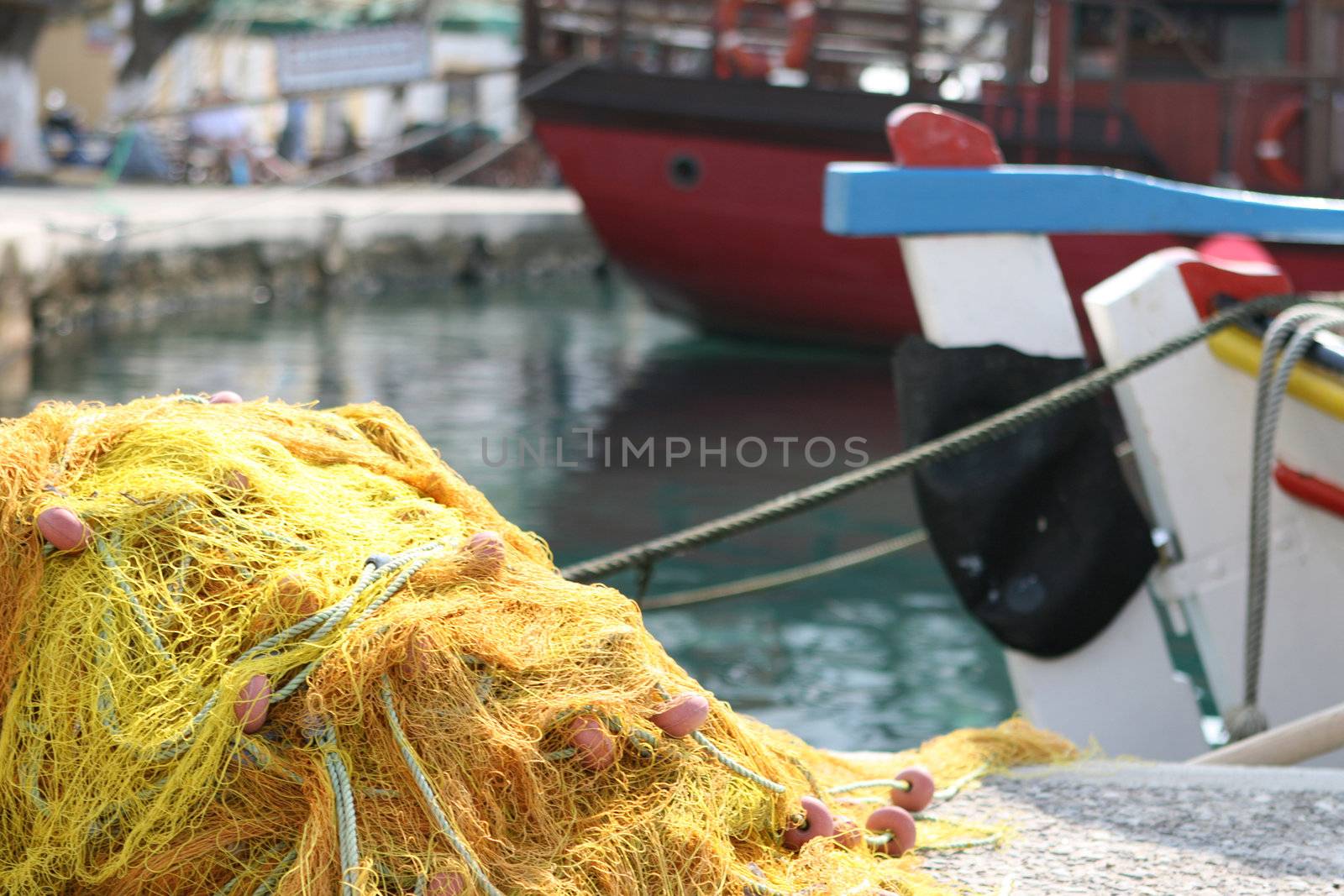 detail from  yellow fishingnet and boats background blur