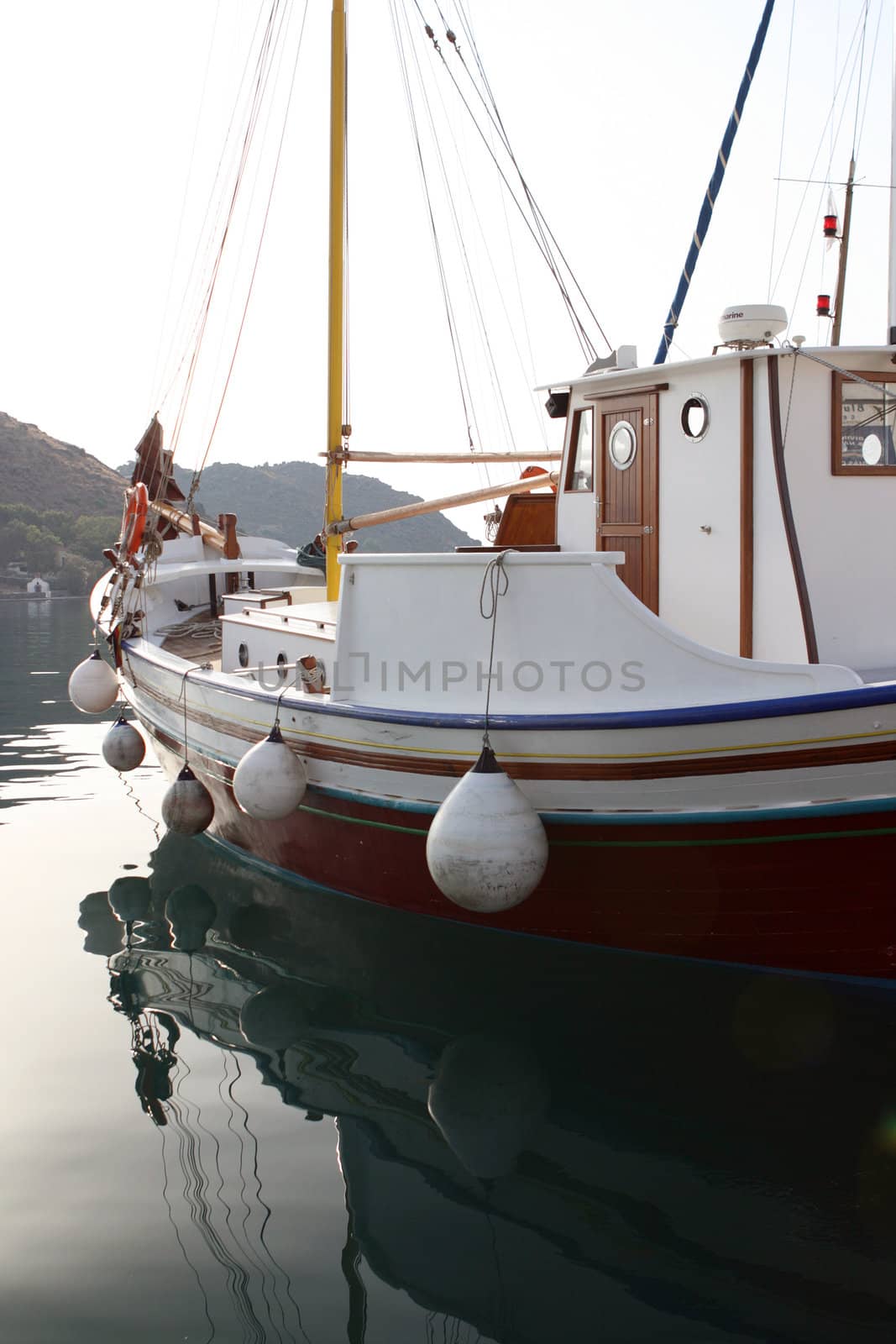 detail from traditional wooden sail boat reflected on water patmos greece