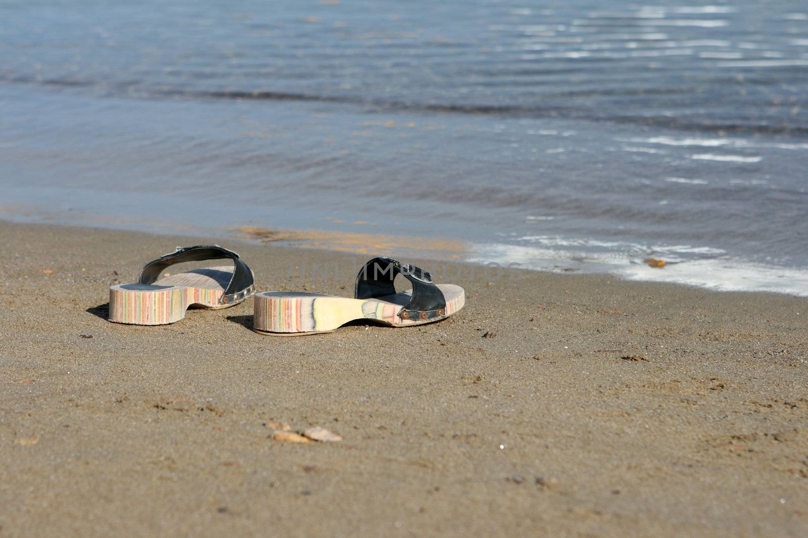 closeup couple of woman sea slippers on the beach with copy space