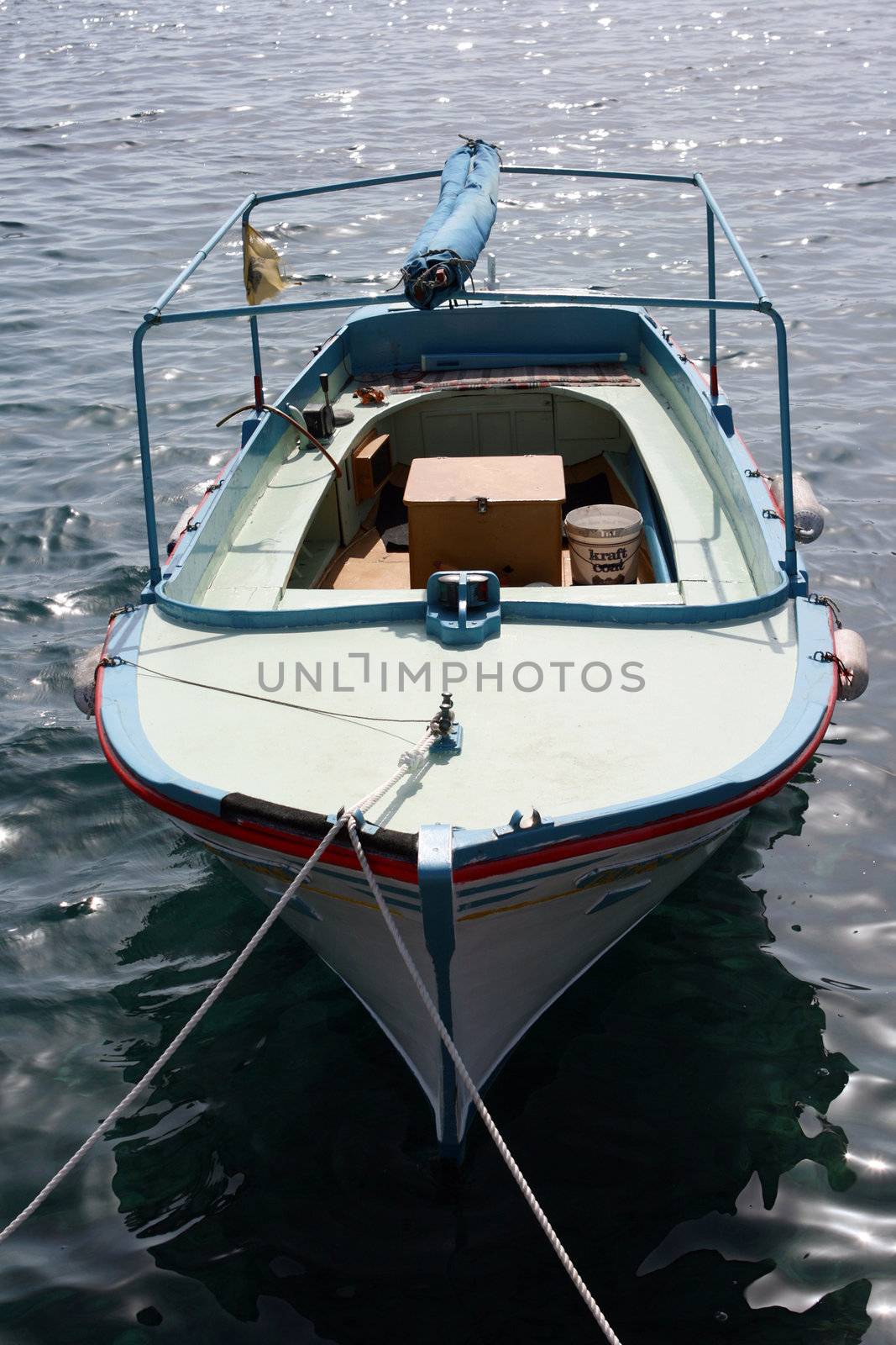 small wooden fishing boat anchored 