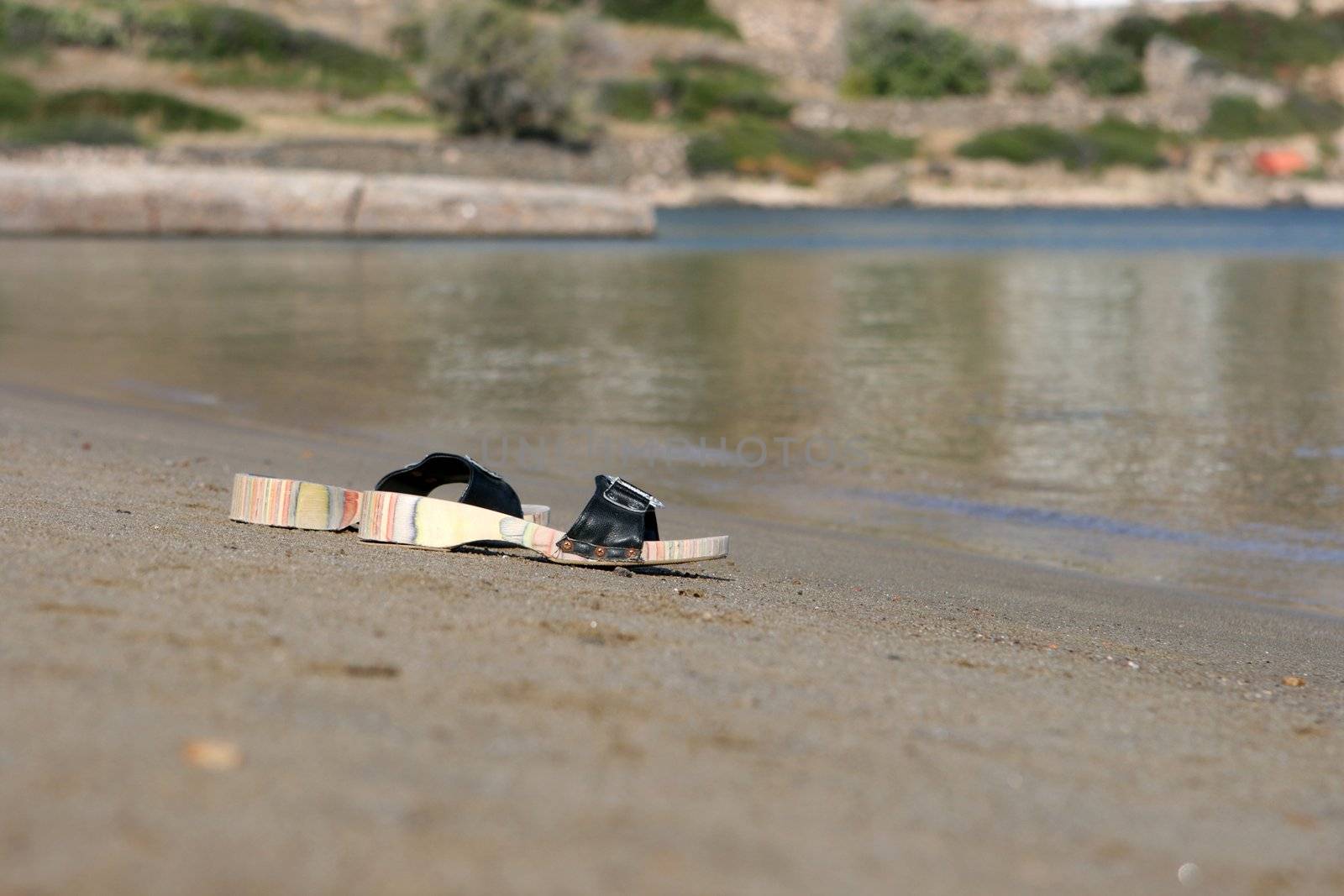 pair of slippers on the beach dof background holidays concepts