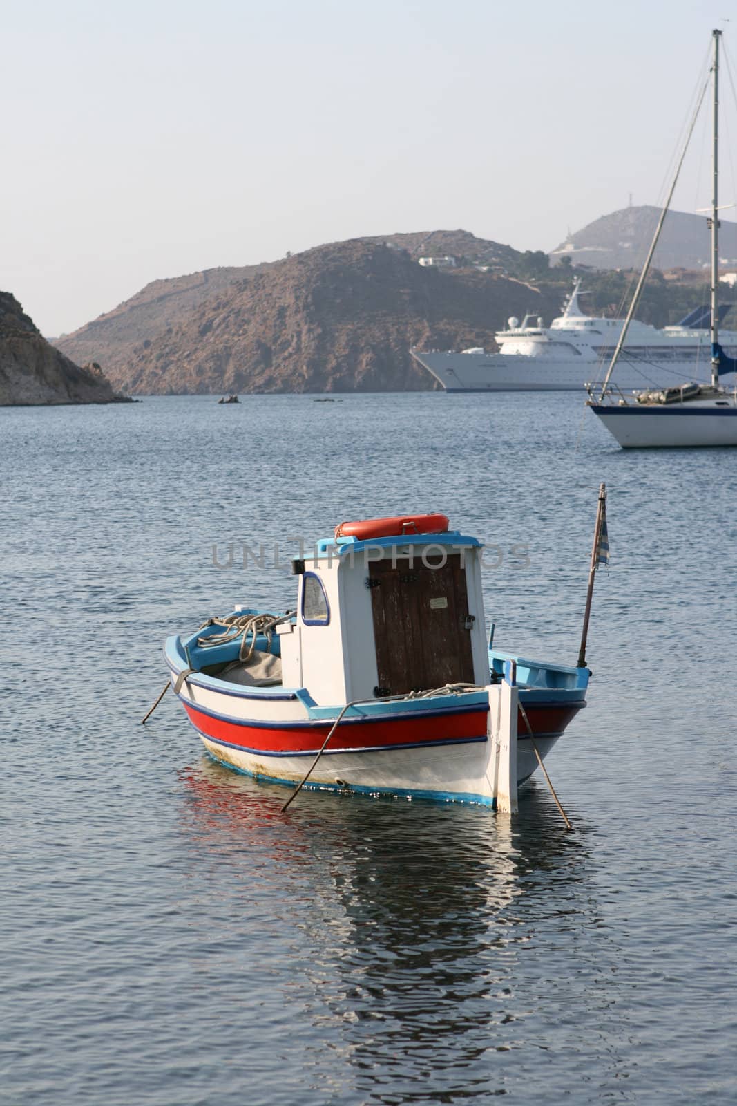 small boat yacht and cruise ship moored at patmos island greece