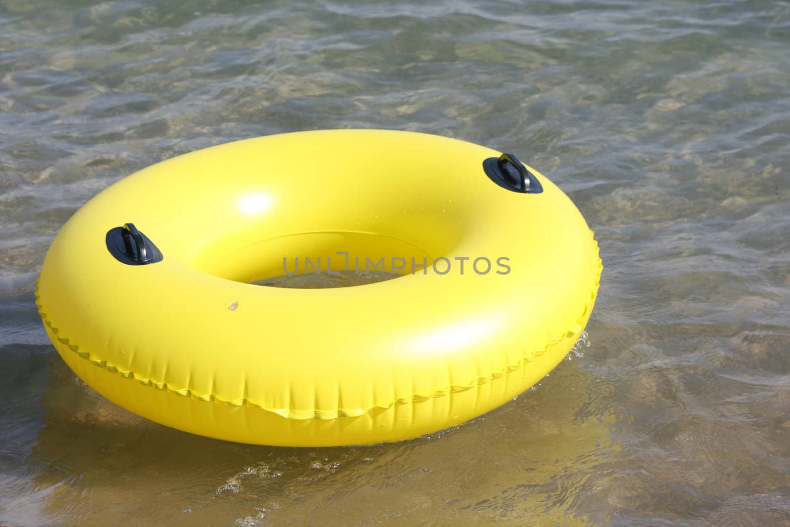 large yellow Inflatable Swimming Ring floating in the sea