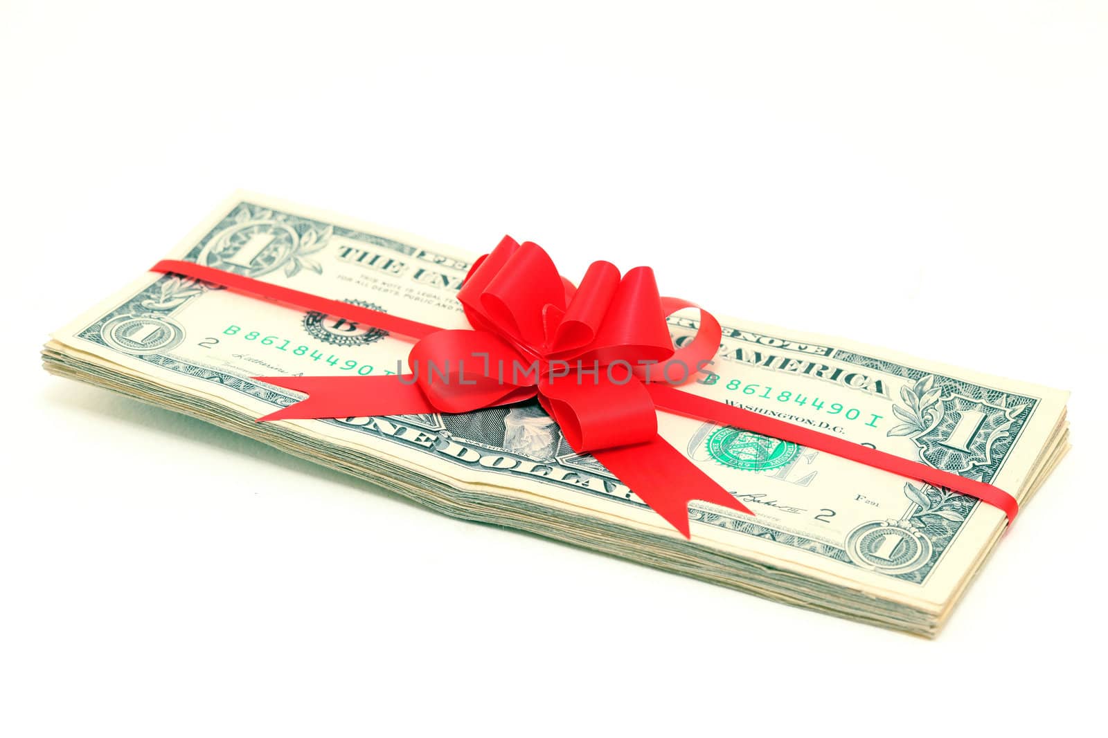 stack of dollar banknotes with red ribon and bow isolated 