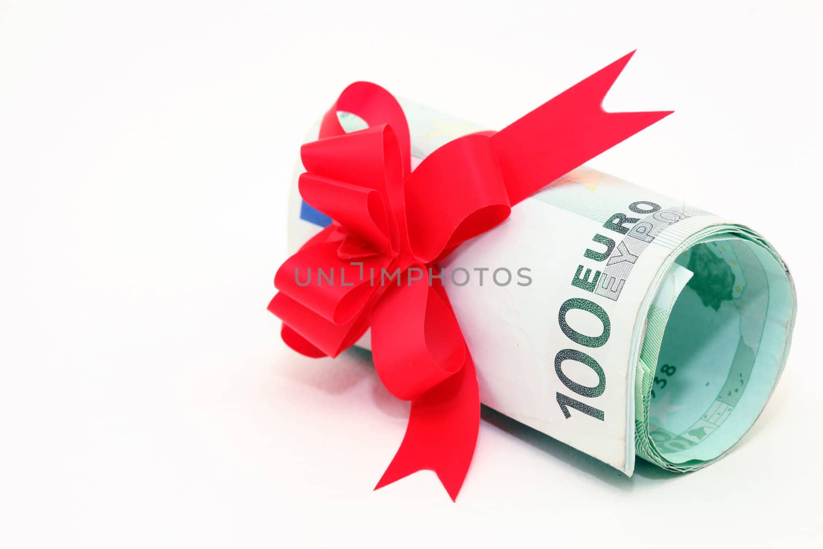 hundred euro banknotes rolled with gift ribbon isolated