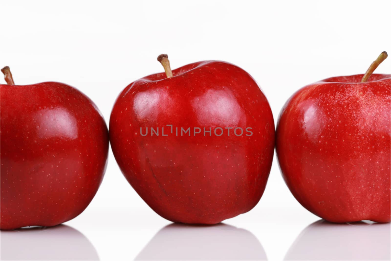 Three shiny red apples by jarenwicklund