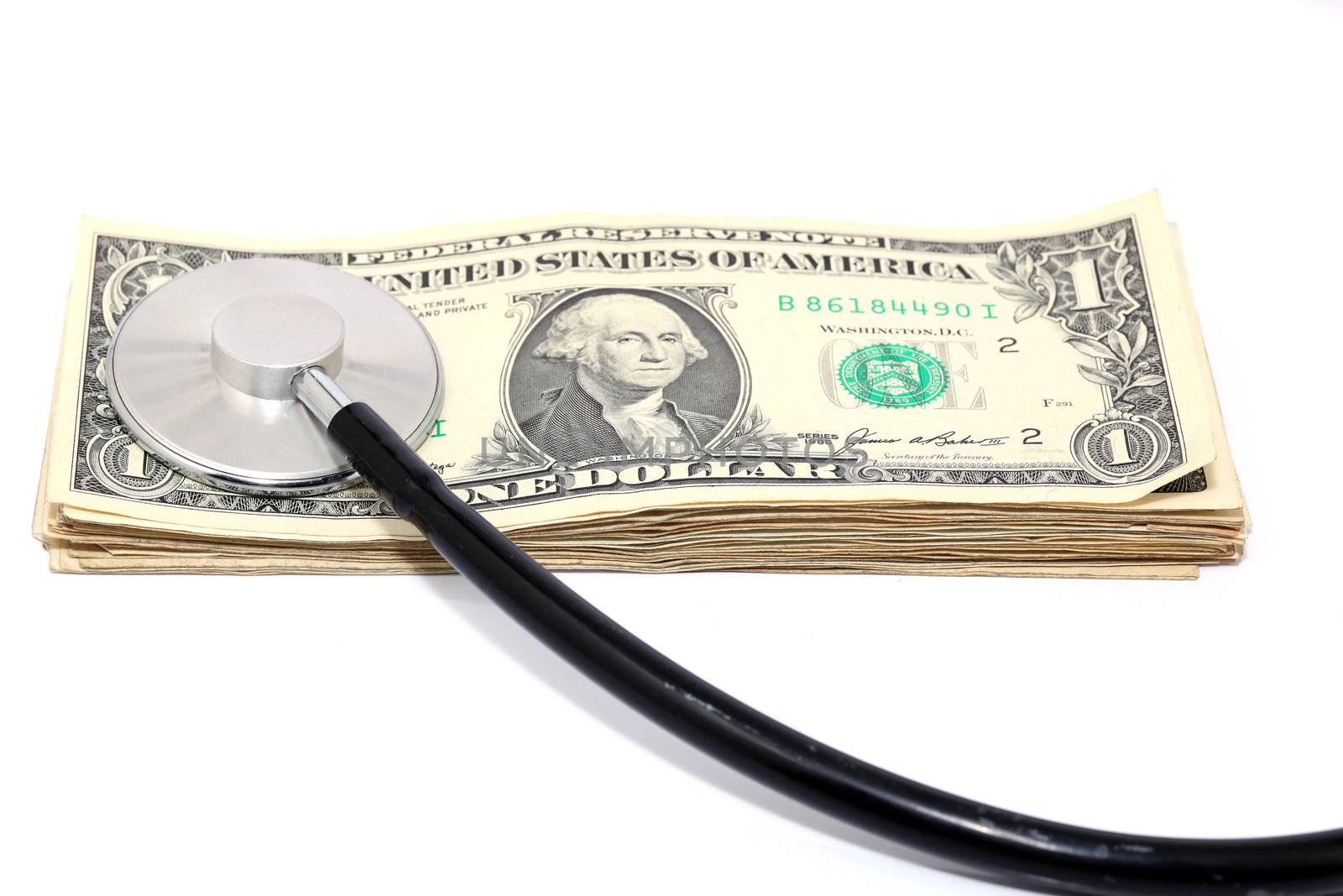 expensive health treatment stethoscope and dollars isolated