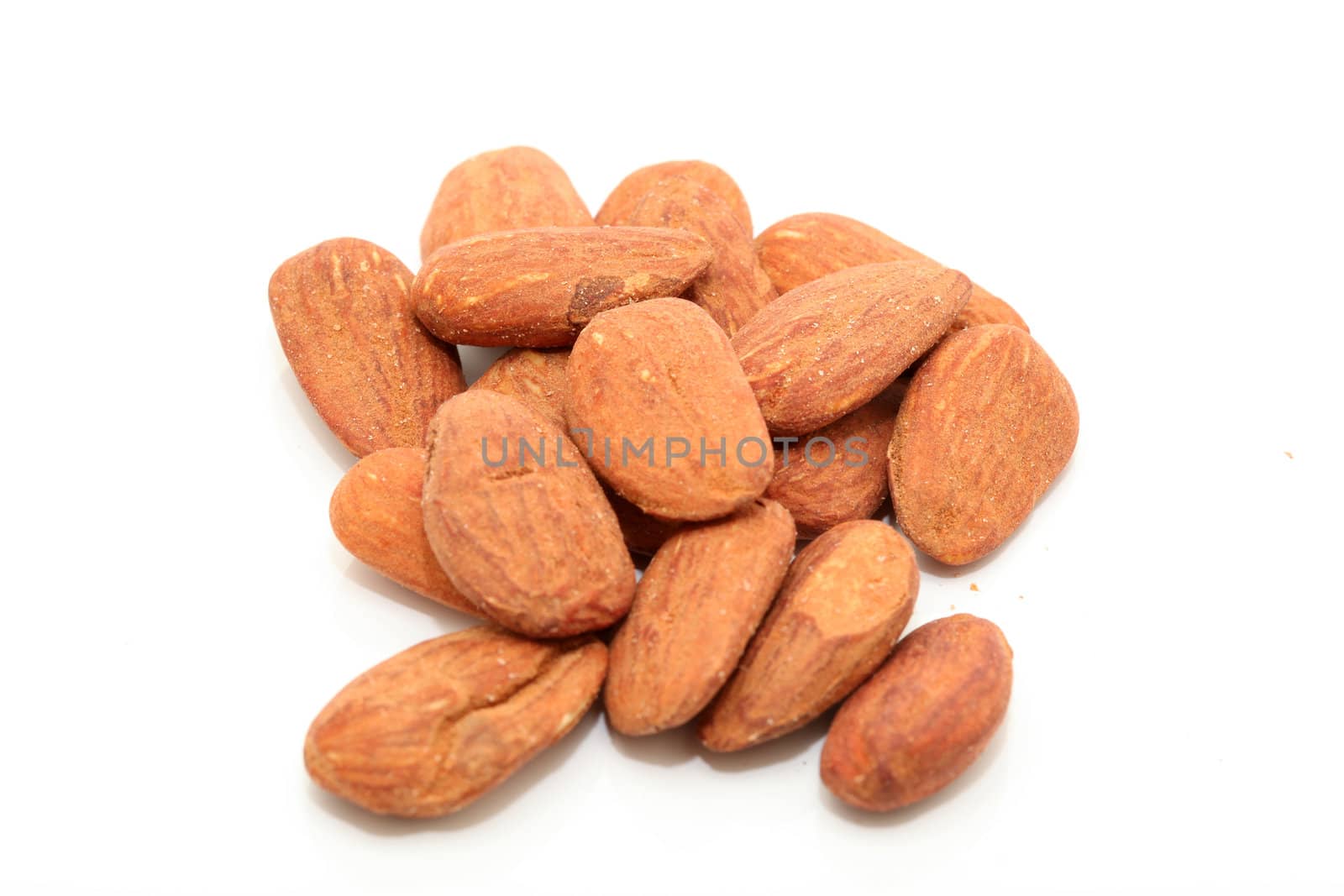 closeup almond nuts rasted and salted isolated on white background