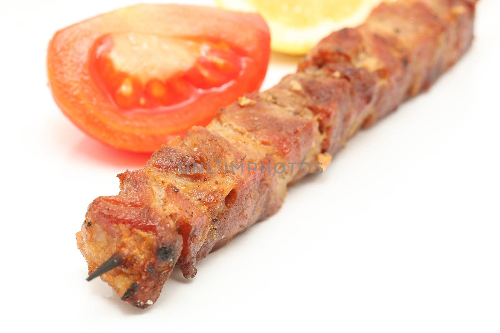 tomato lemon and  pork kebap on wooden stick  isolated 