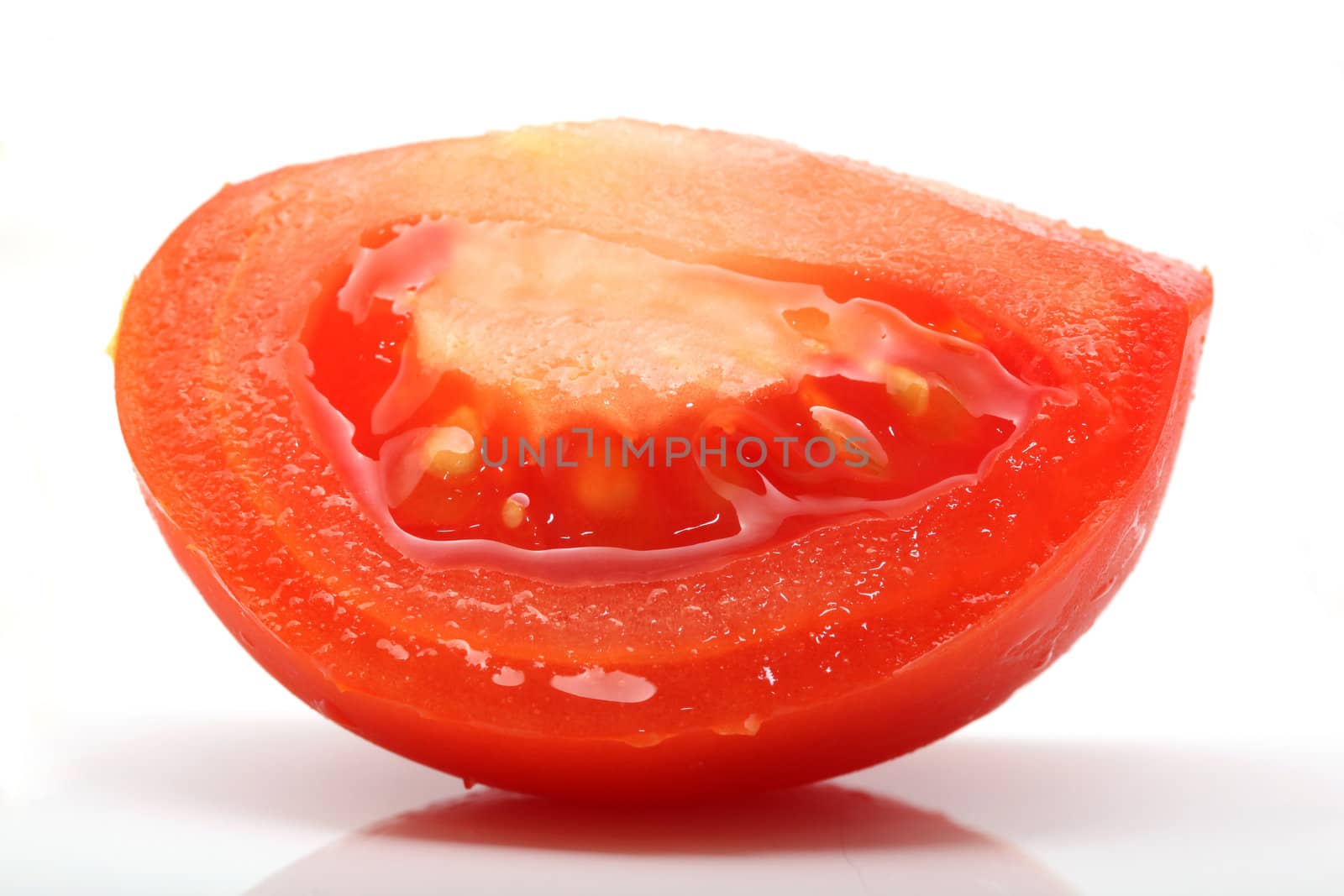 piece of juice tomato closeup isolated on white background