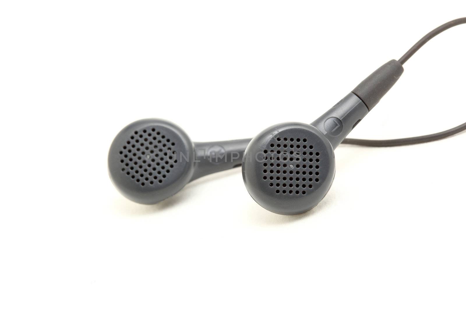 small black streophonic earphones closeup isolated on white background