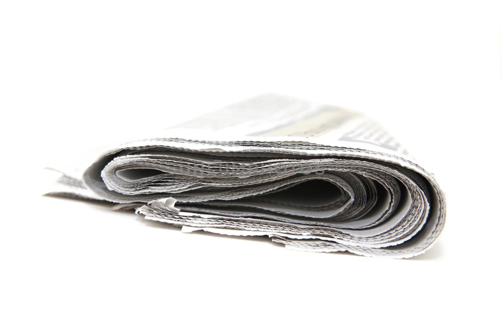 closeup detail from folded newspaper isolated on white background