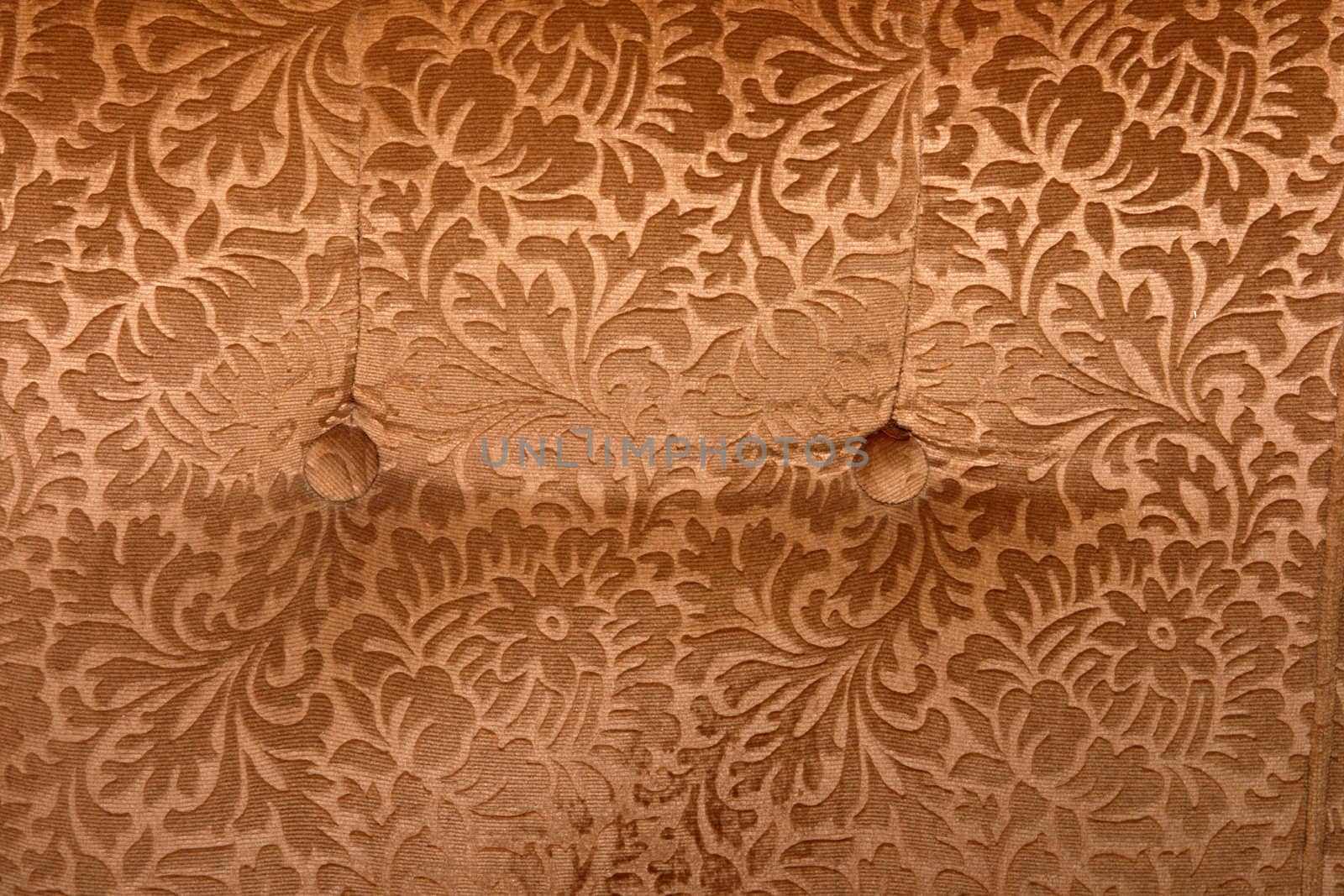 abstract retro golden velvet textile detail with butons from couch