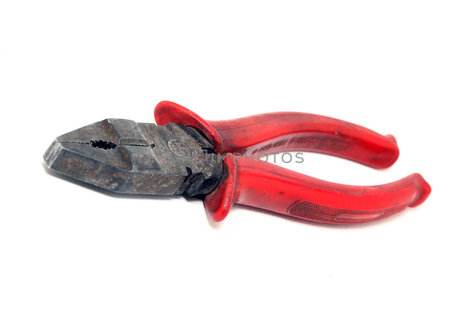 old used plier with red rubber handle isolated