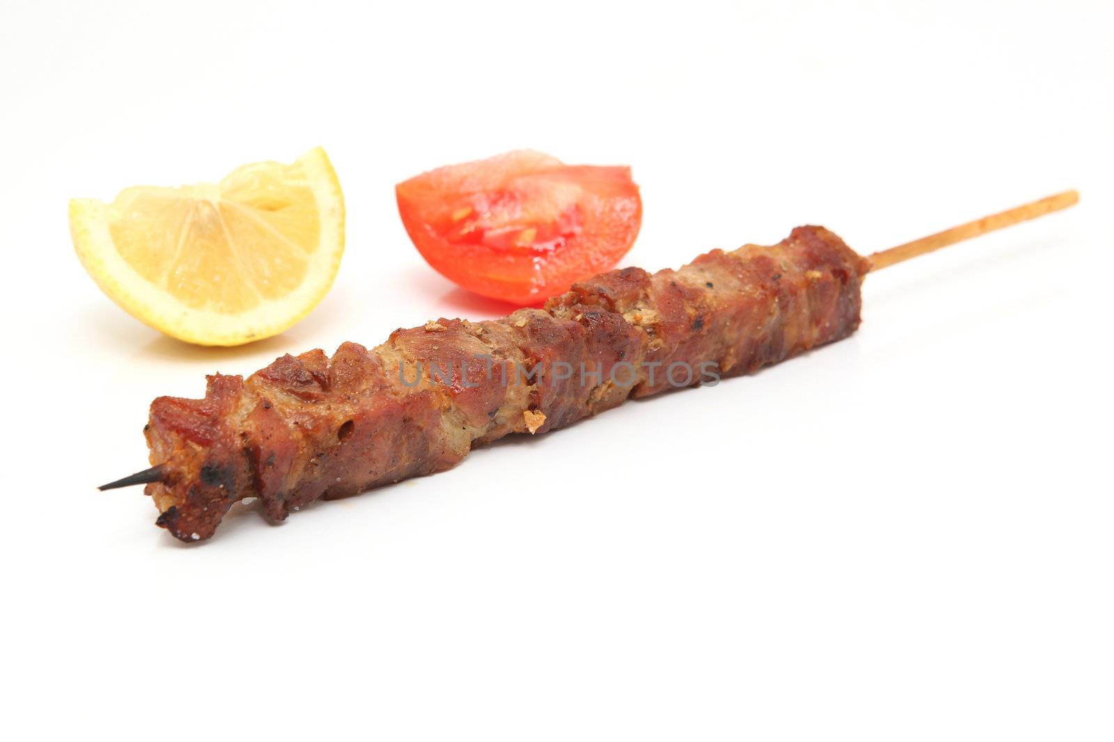 kebap on stick lemon and tomato background isolated