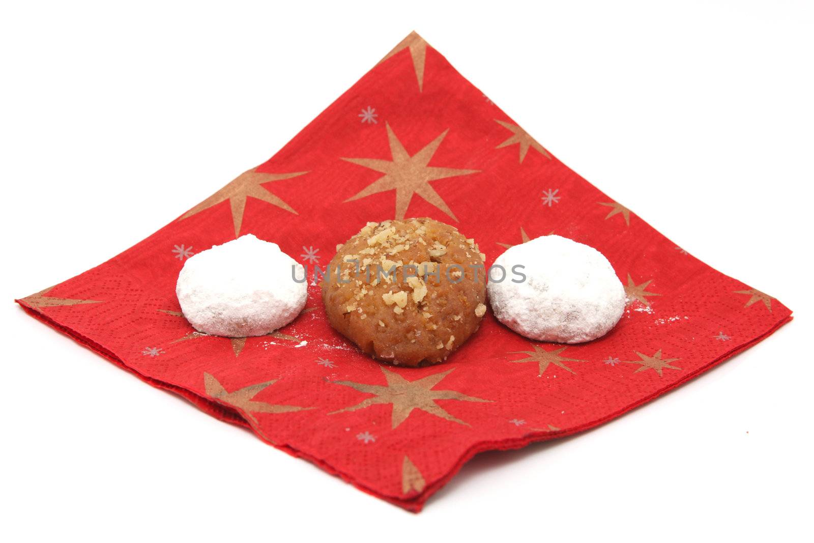 two traditional Greek Christmas sweets  melomakarona and kourampie on red paper napkin