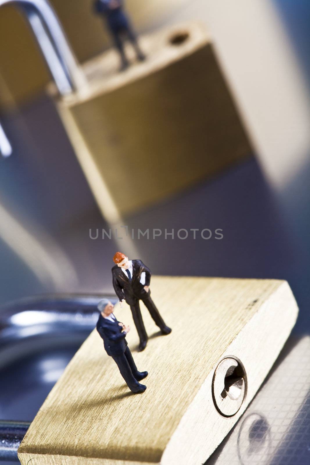 Business man on secure pedlock by JanPietruszka