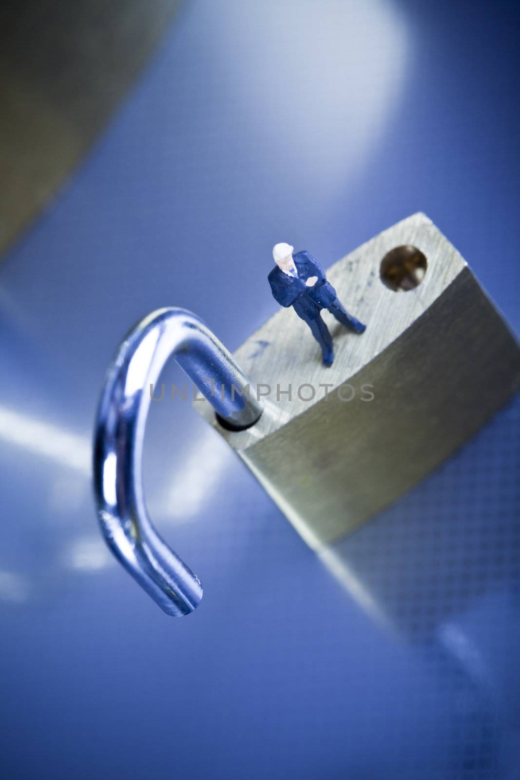 Business man on secure pedlock by JanPietruszka