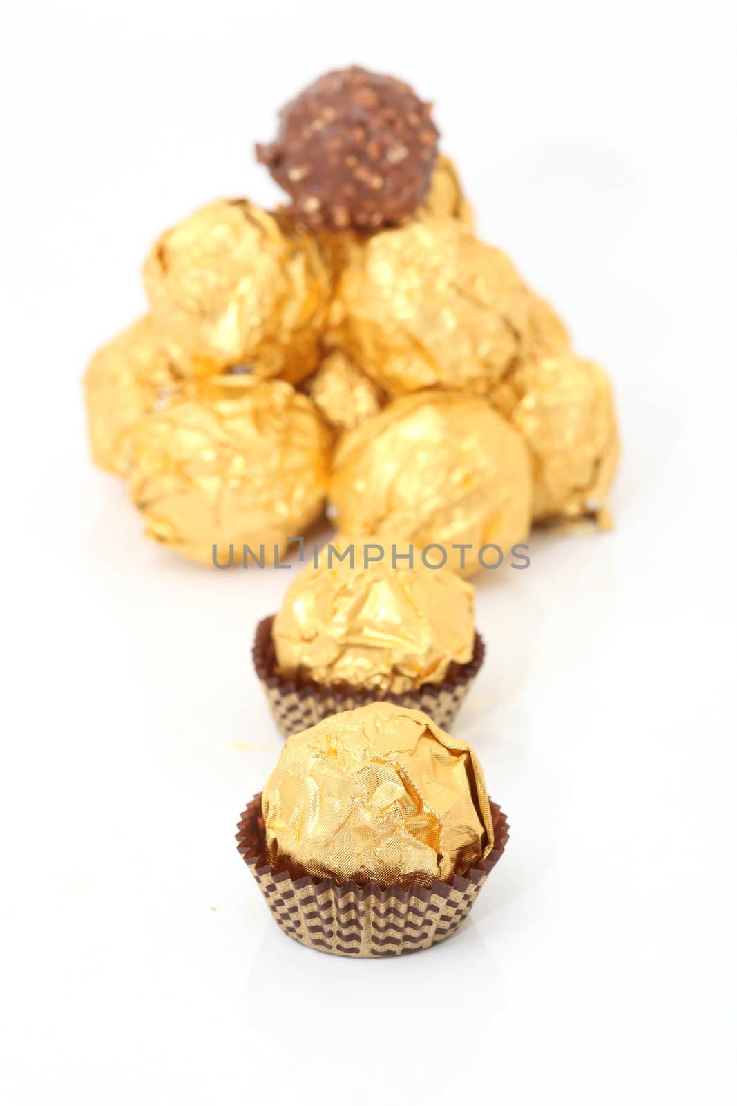 gold wraped chocolate sphere dessert isolated on white background