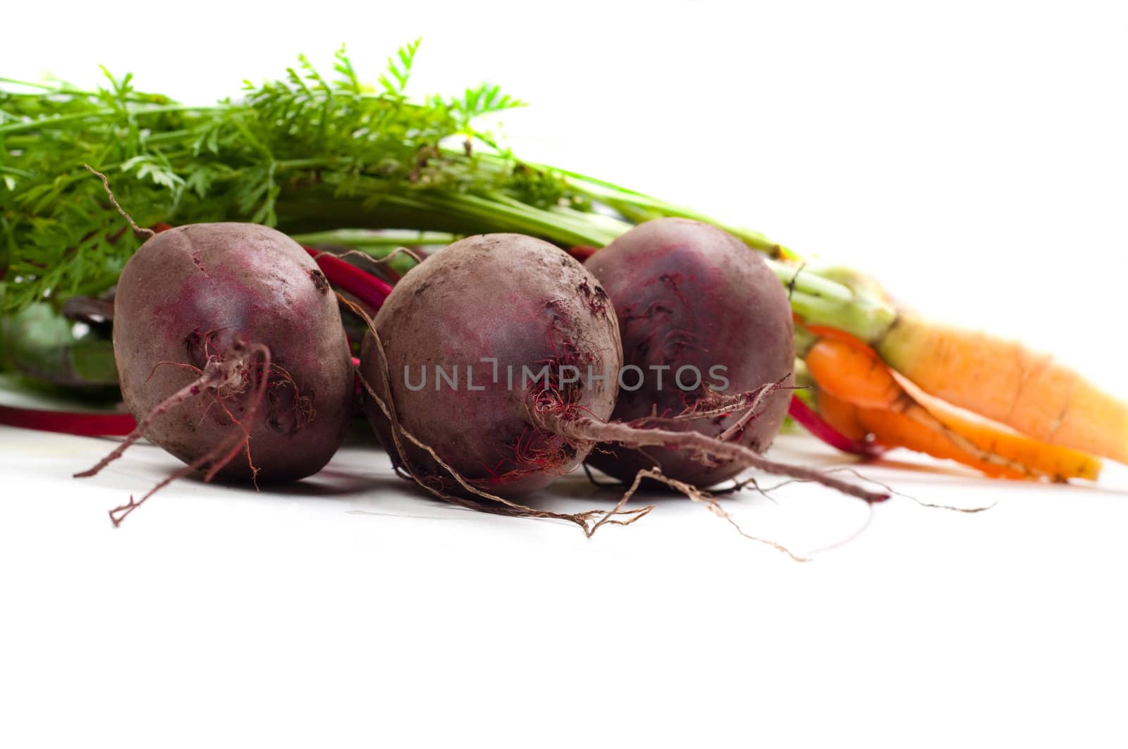 Shot of young beet and carrot isolated on white