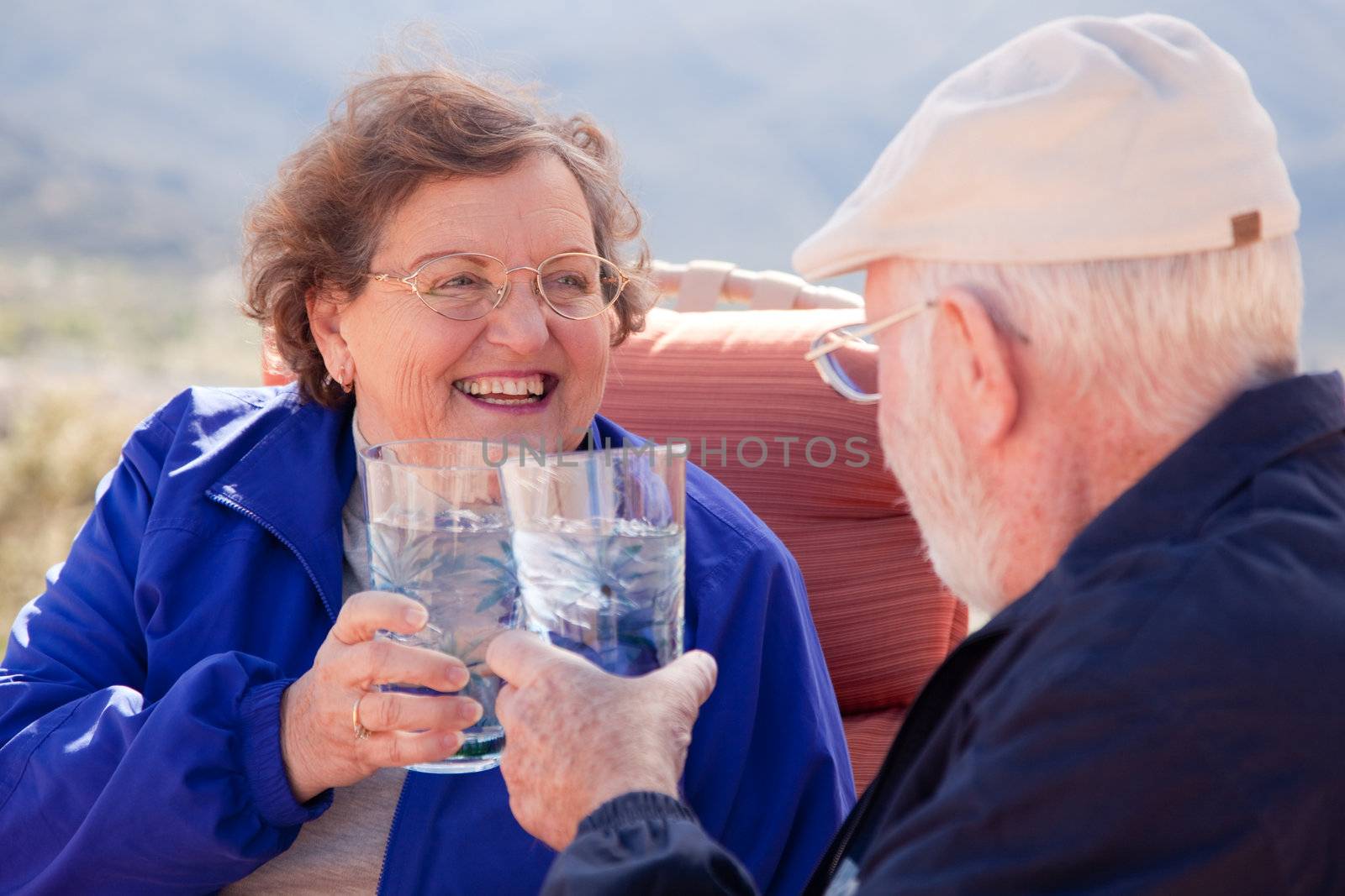 Happy Senior Adult Couple with Drinks by Feverpitched
