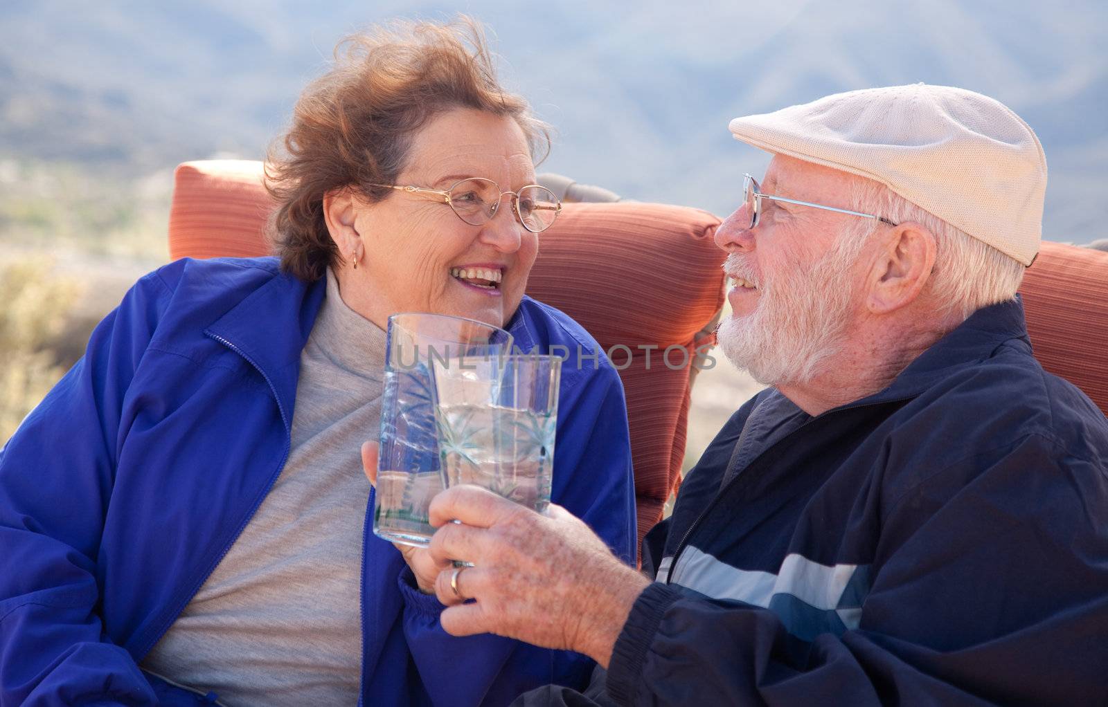 Happy Senior Adult Couple with Drinks by Feverpitched