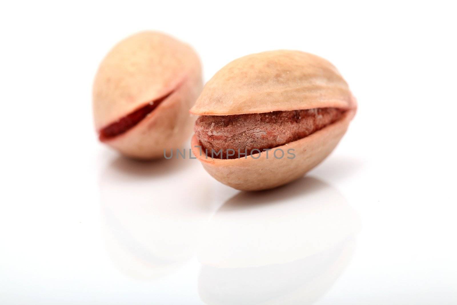 two pistachios closeup detail isolated on white background with copyspace