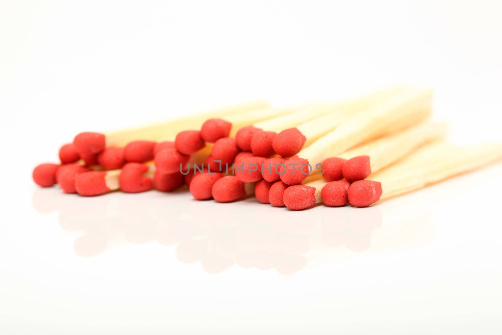 stack of wooden matches sticks closeup detail with reflection isolated