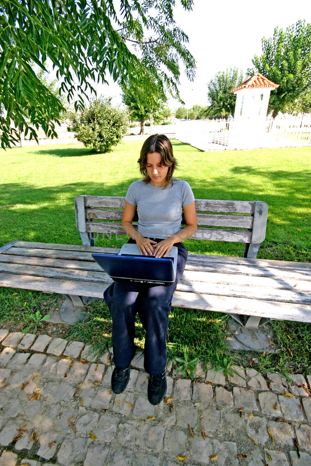 woman working on a laptop on a park