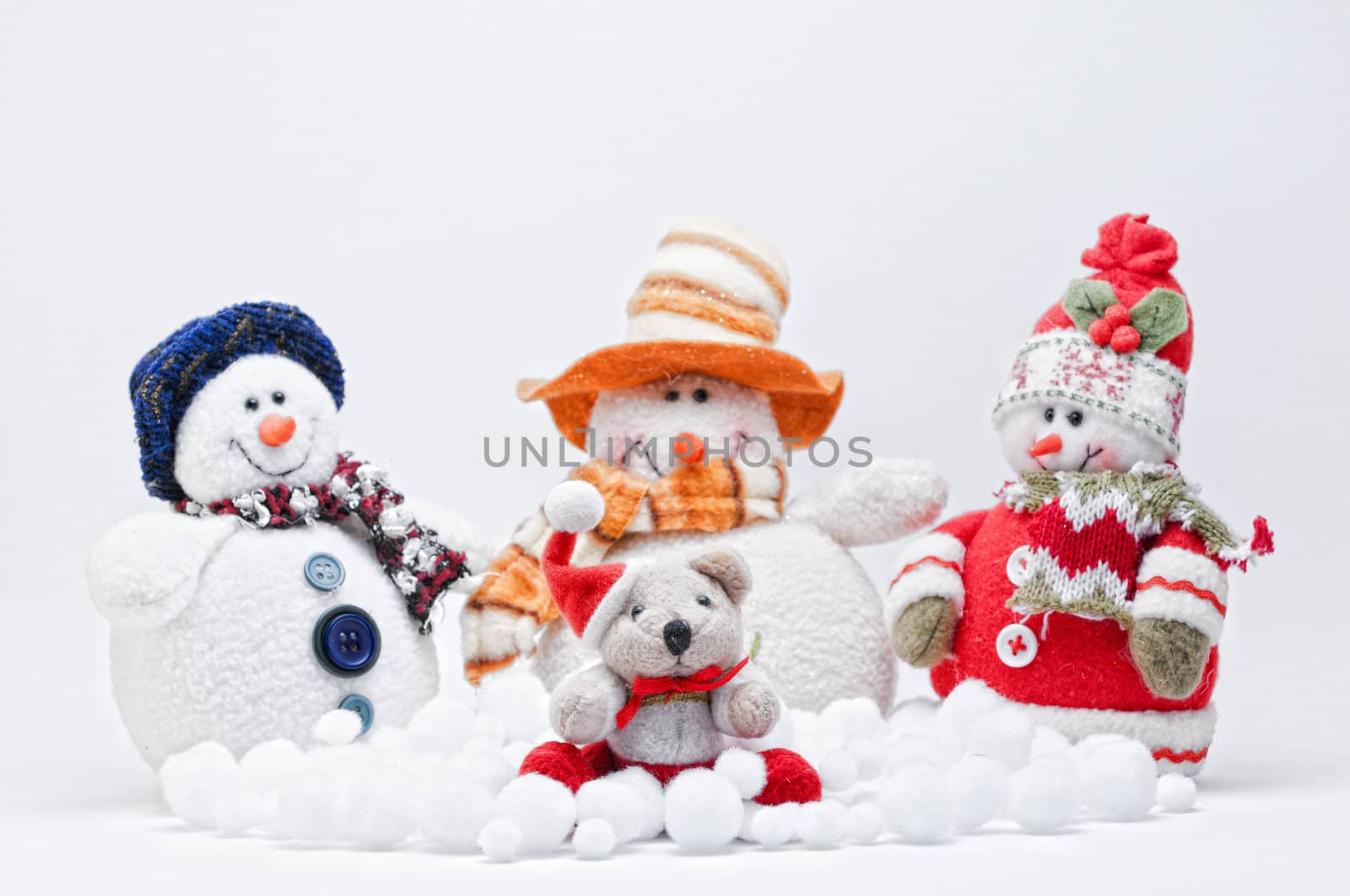 Christmas Teddy with three Snowmen on a white background.