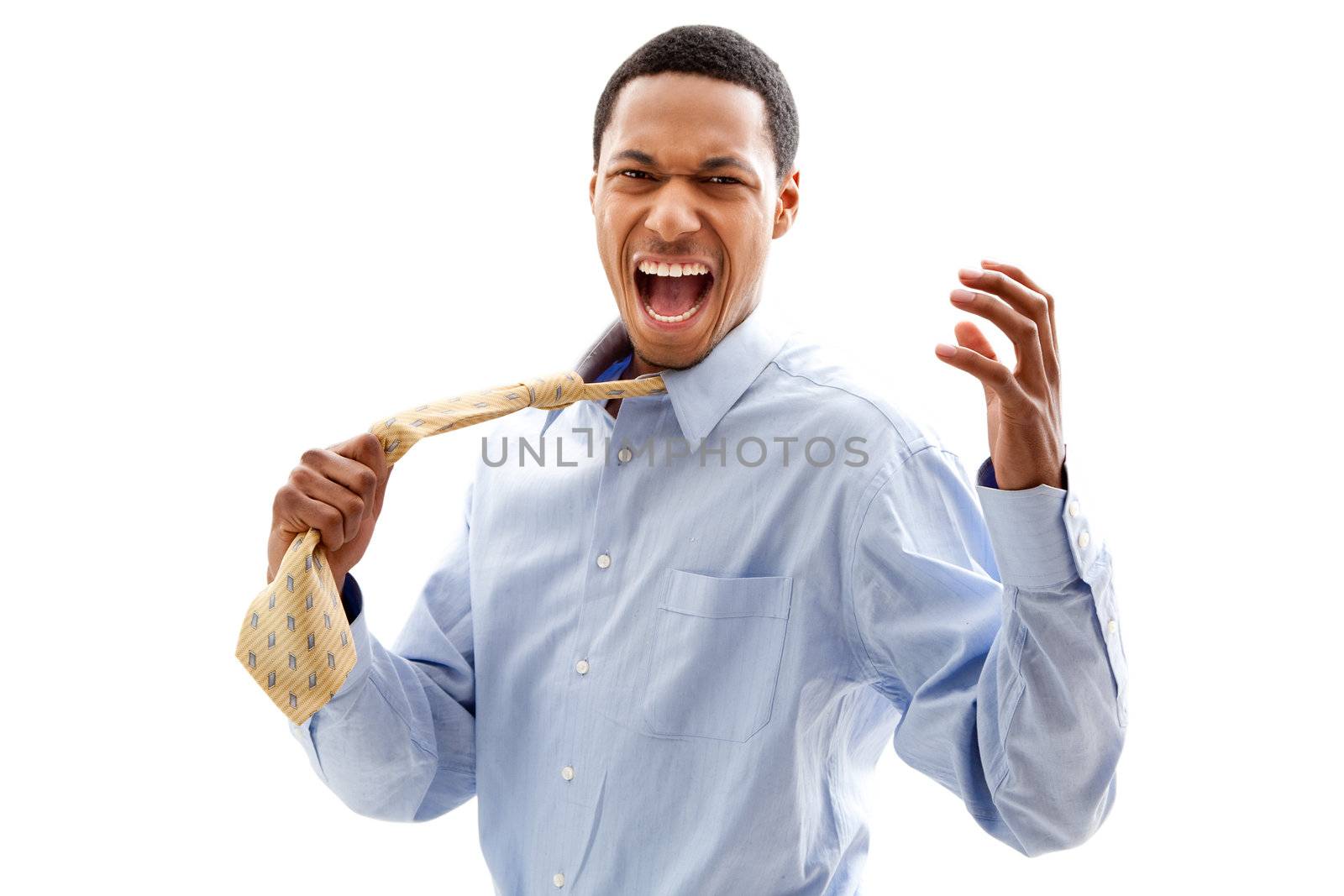 Angry screaming African American business man in blue shirt pulling yellow tie, isolated