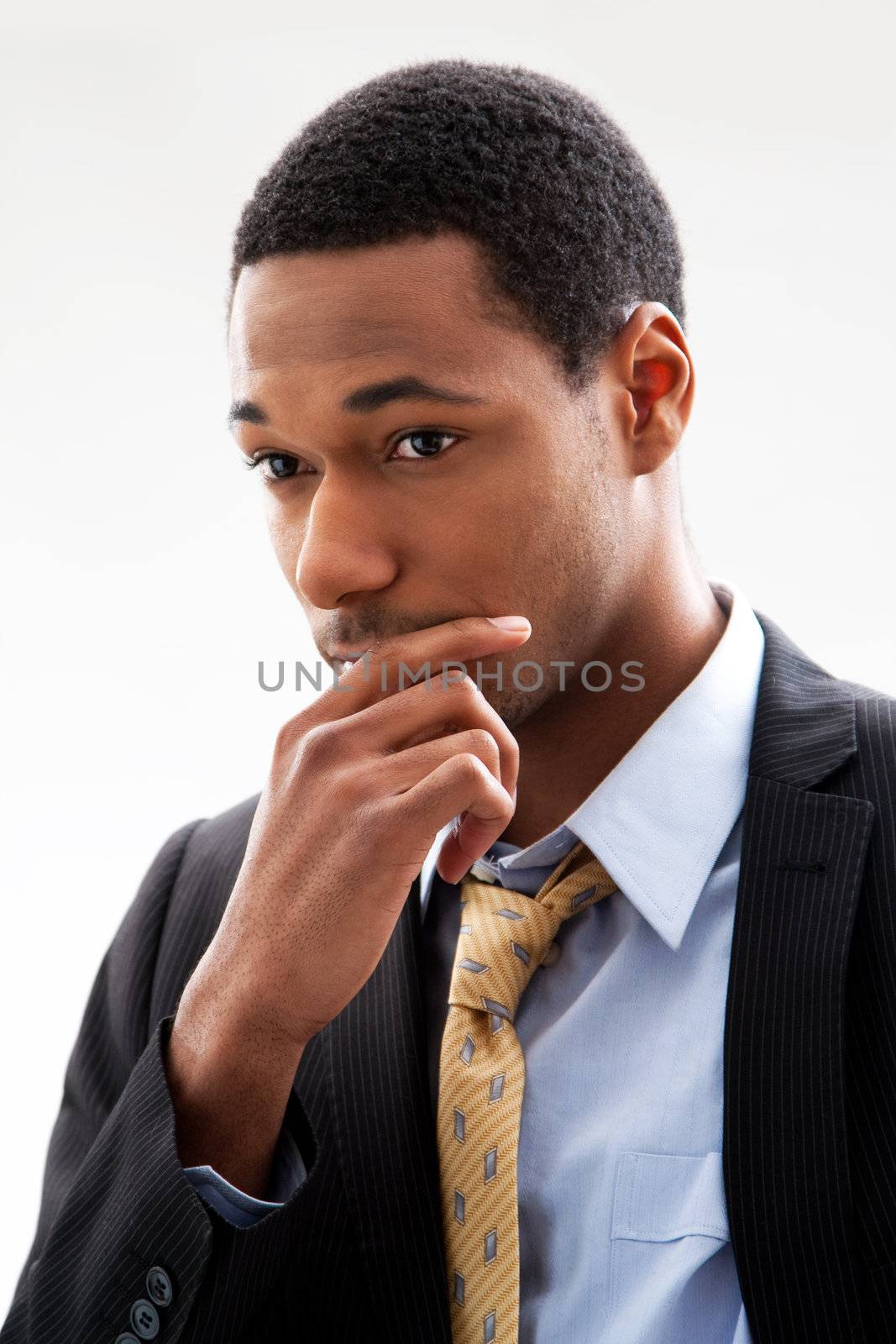 Handsome African American male in blue shirt and yellow tie and black pinstripe blazer, isolated