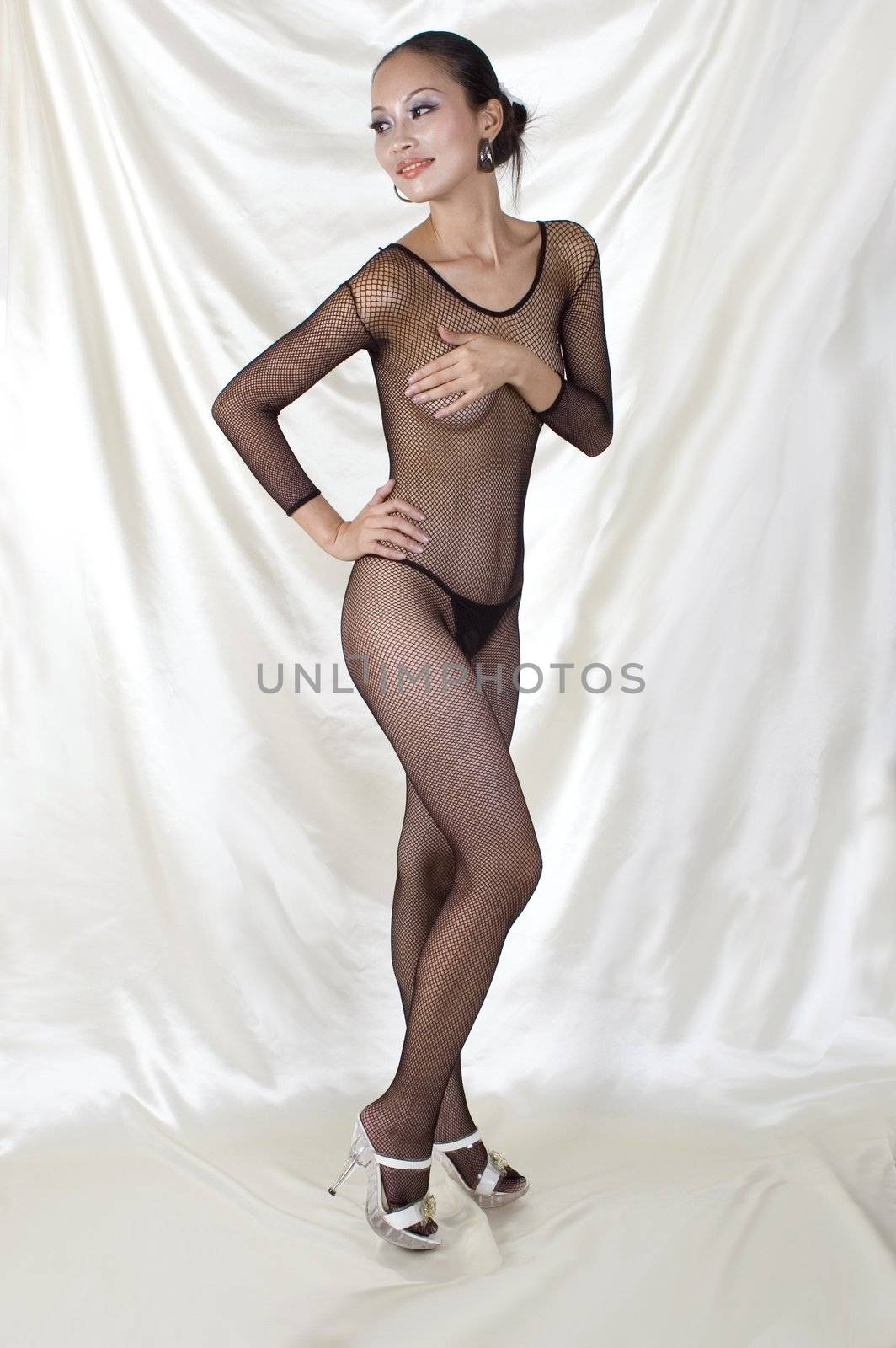 Sexy Asian girl in bodystocking, erotic photo session with beautiful girl, good shape, kind face expression. Gently covered nudity. 