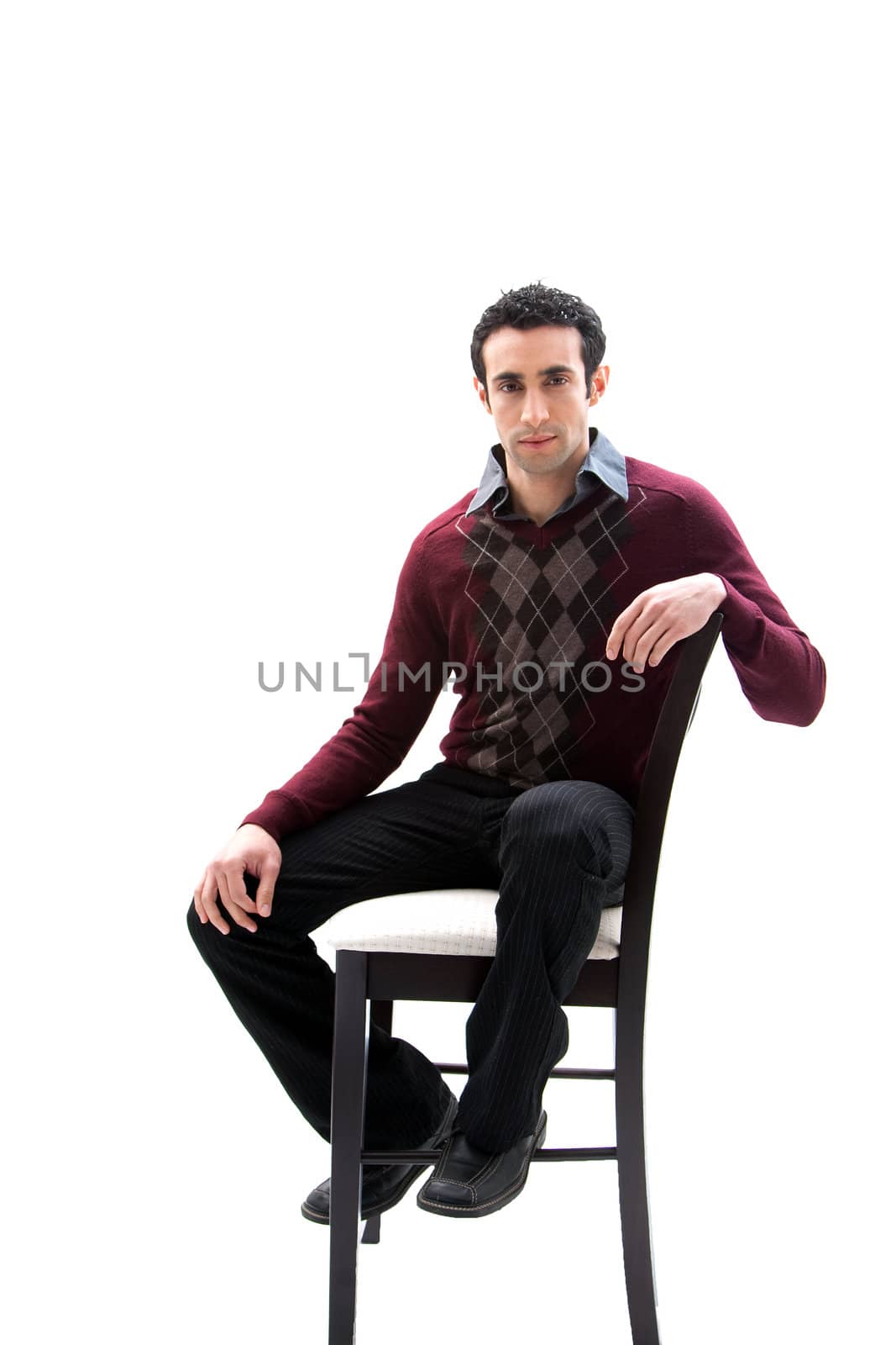 Handsome guy wearing business casual clothes sitting on a high chair, isolated