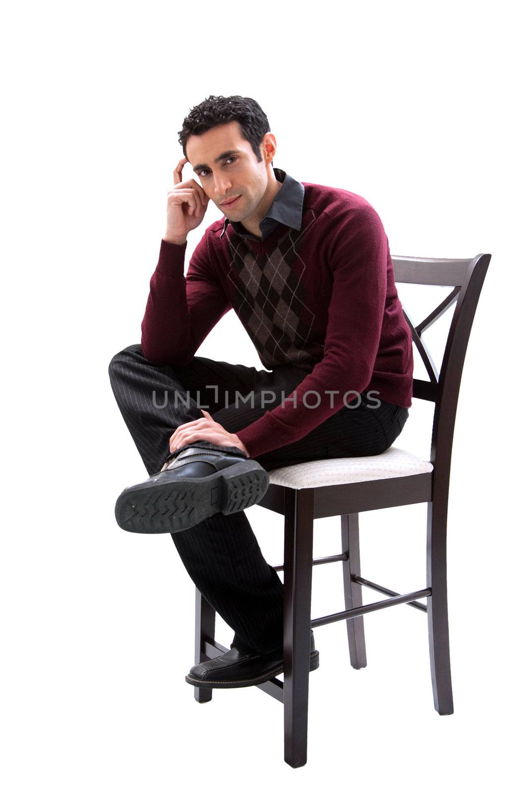 Handsome guy wearing business casual clothes sitting on a high chair and thinking, isolated