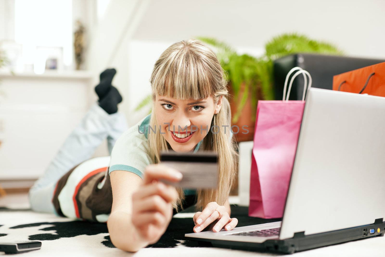 woman shopping online via Internet from home by Kzenon