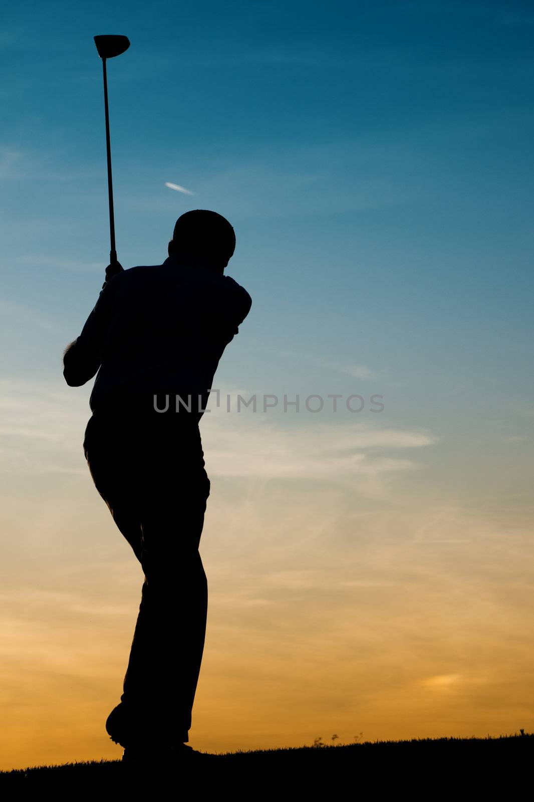 Senior male golf player at sunset by Kzenon