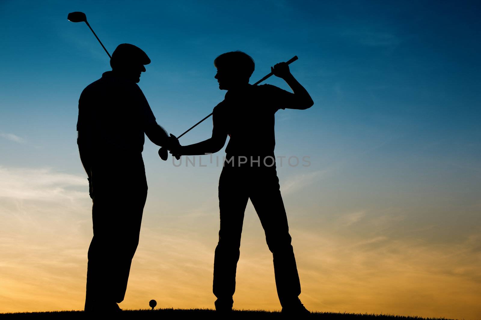 Senior couple playing Golf at sunset by Kzenon