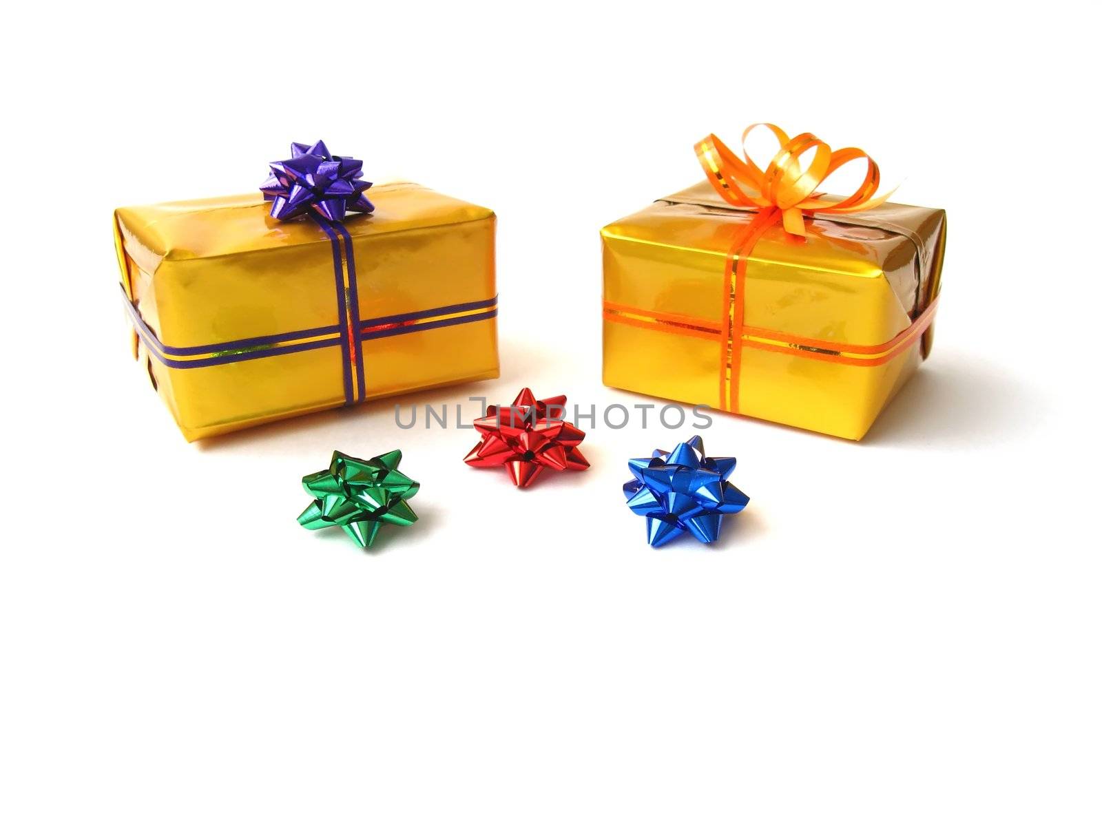 present boxes in gold wrap and colorful belts with bows 