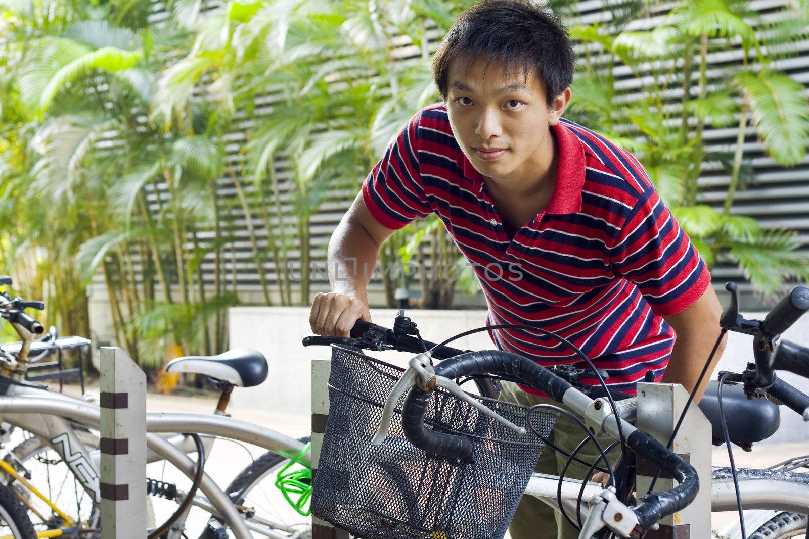 asia man take bike in bicyle park