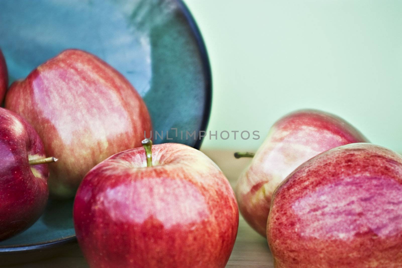 Red apples spilling from a bowl
