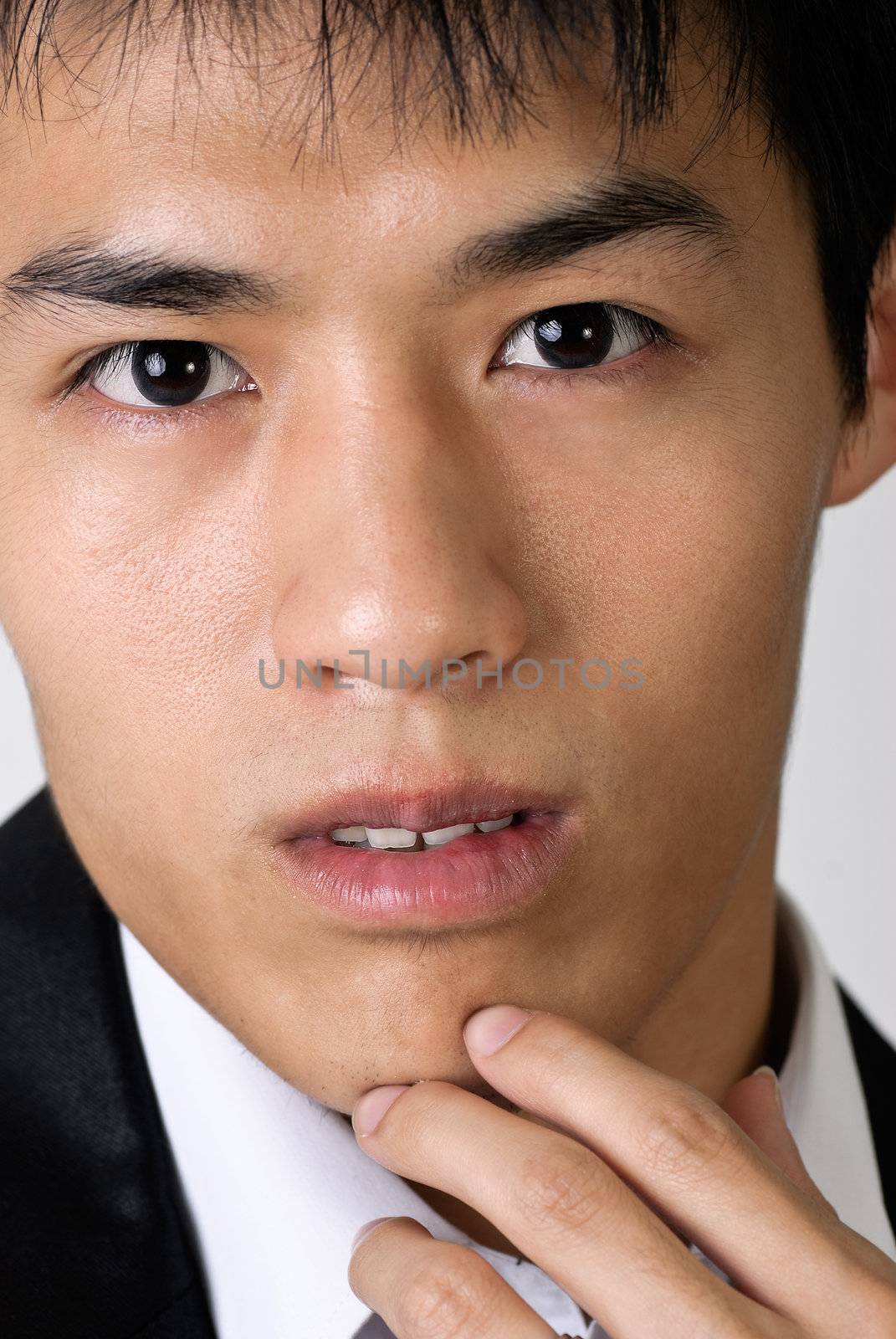 Closeup portrait of young business man face.