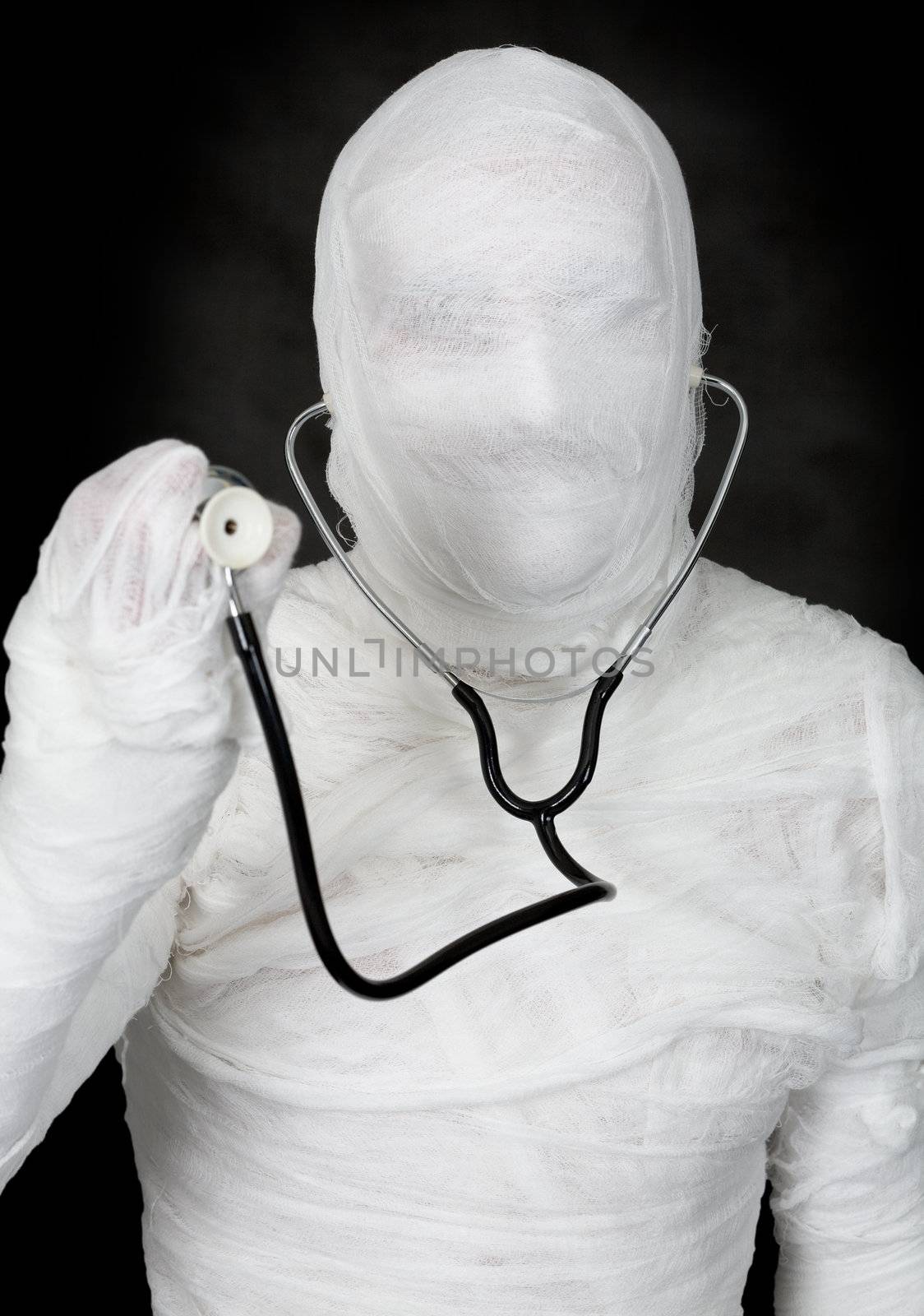 Mummy and stethoscope on the black background