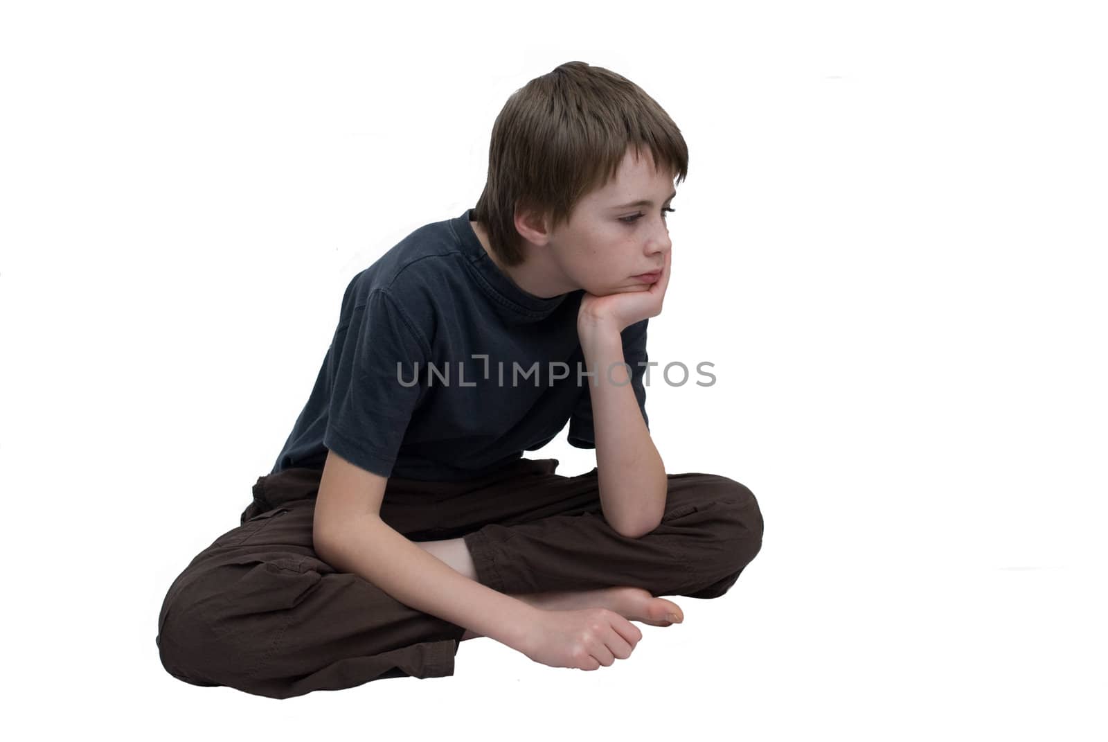 a young boy looking bored and fed up.