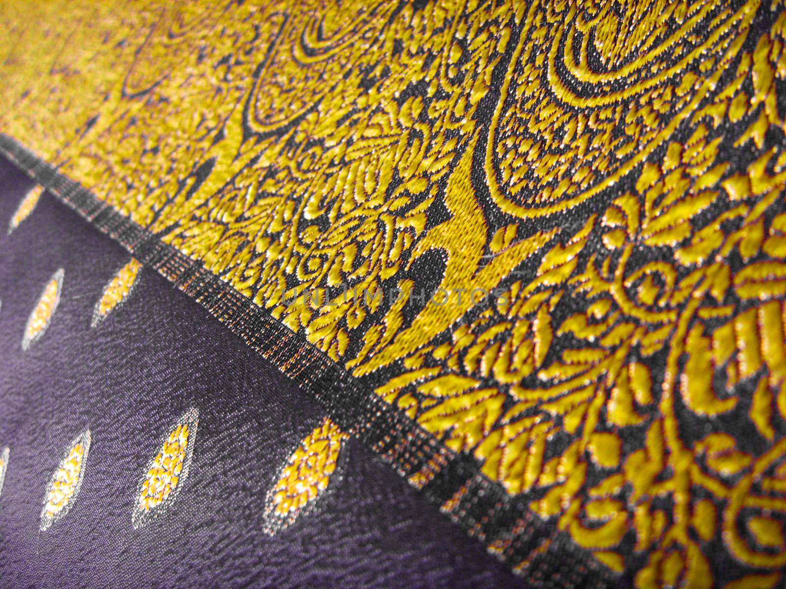 Beautiful floral design on a indian black and gold fabric known as a saree/sari