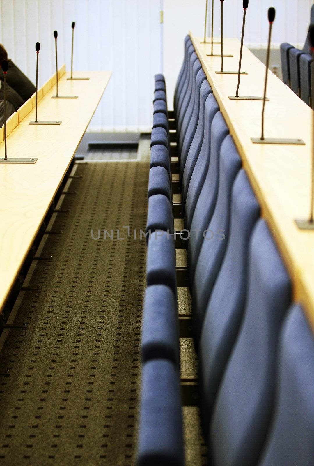 Detail of interior of court room with seats and microphones