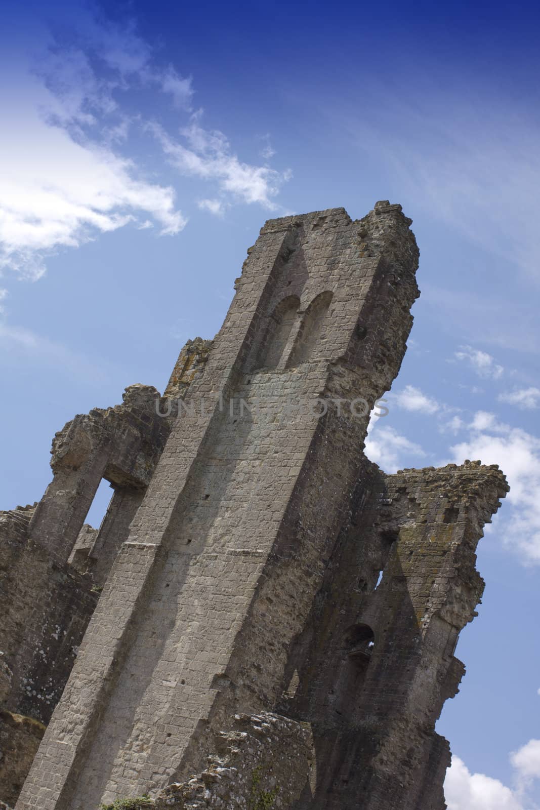 The 1000 year old crumbling ruins of Corfe castle rising above the Isle of Purbeck in Dorset,, England. Built in Roman times the castle was once a controlling gateway through the Purbeck Hills.